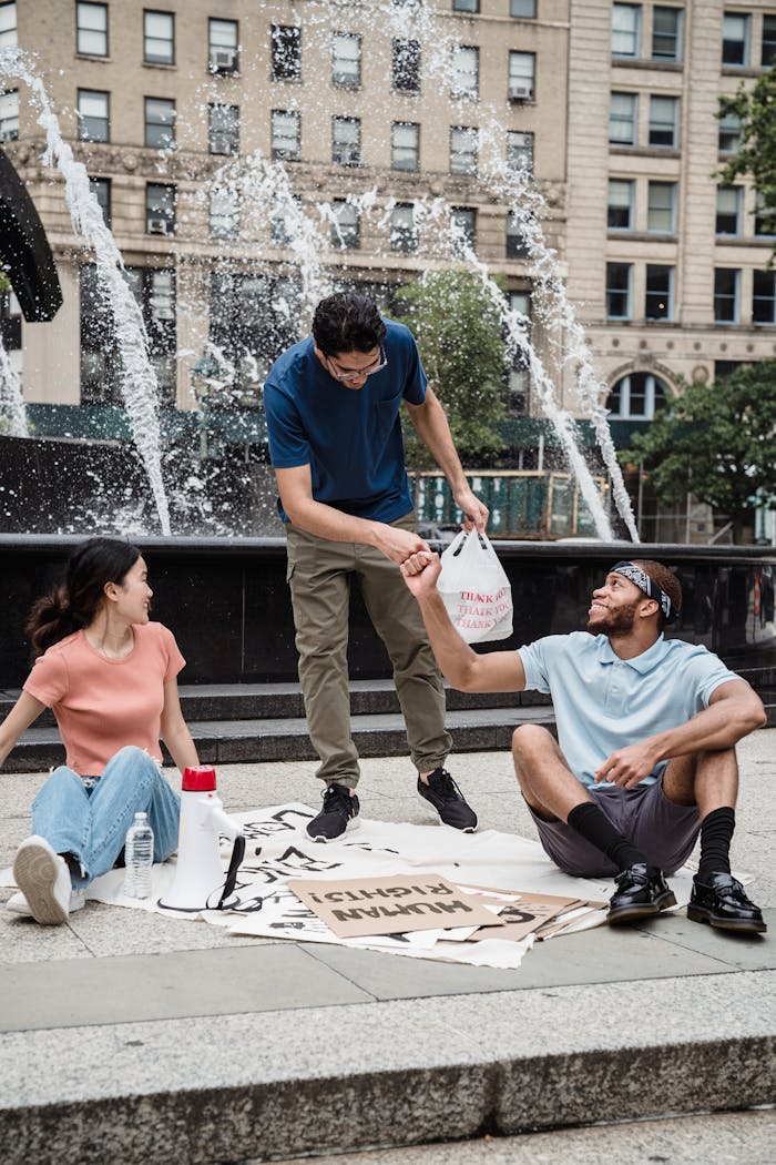 A diverse group having a casual meeting near a fountain, emphasizing community and connection.